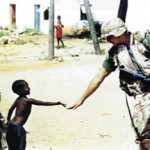 Boy greeting Soldier in Africa.